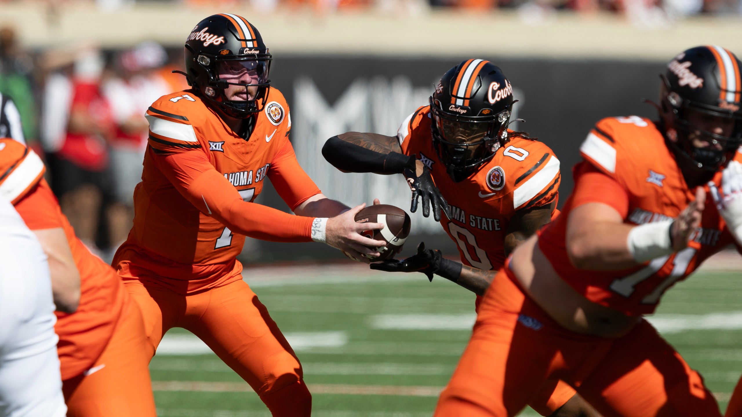 Oklahoma State quarterback Alan Bowman (7) hands the ball off to running back Ollie Gordon II (0) in the first half of an NCAA college football game against Utah Saturday, Sept. 21, 2024, in Stillwater, Okla. (AP Photo/Mitch Alcala)