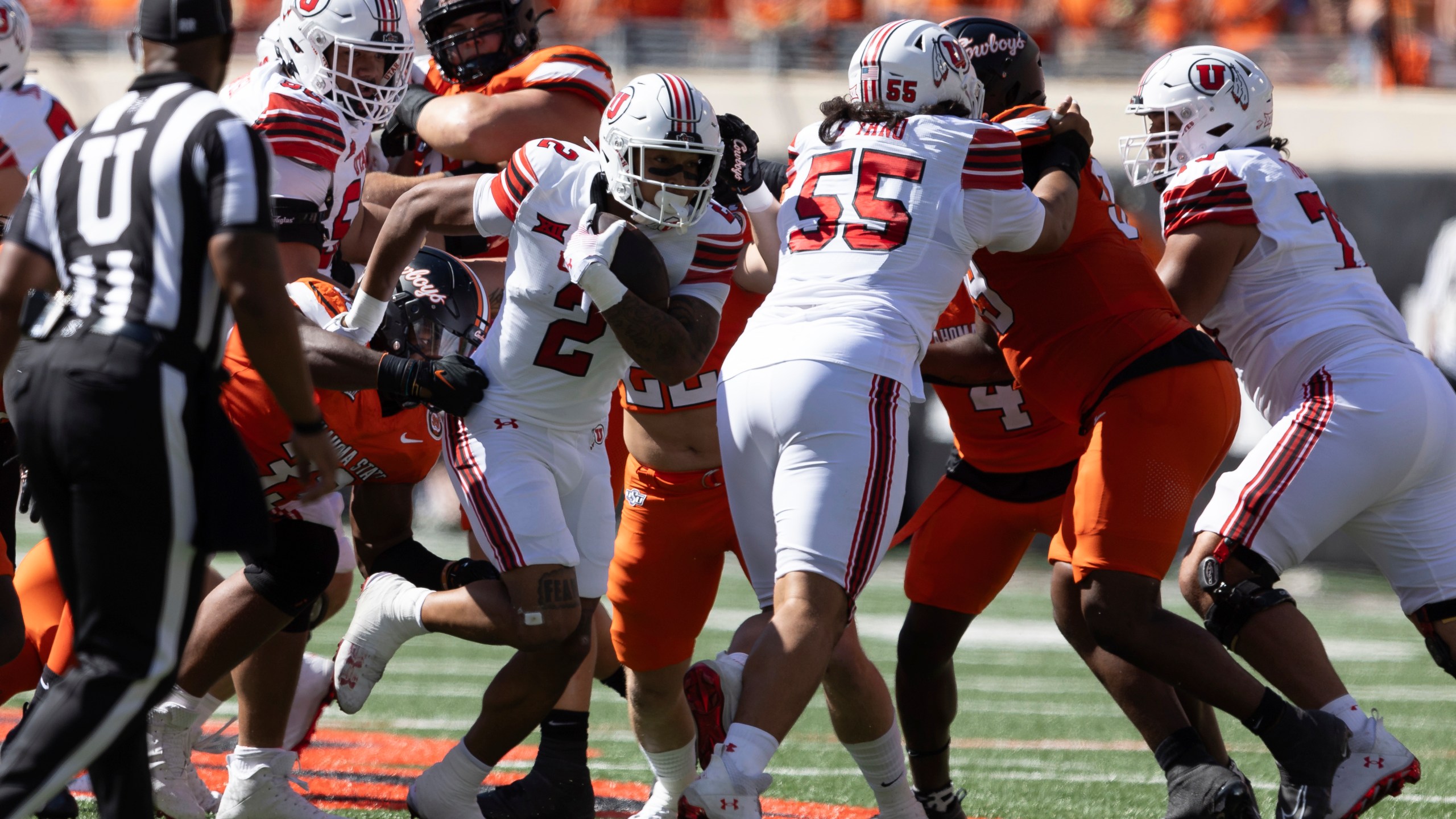 Utah running back Micah Bernard (2) runs past Oklahoma State defensive end Obi Ezeigbo (33) in the first half of an NCAA college football game Saturday, Sept. 21, 2024, in Stillwater, Okla. (AP Photo/Mitch Alcala)