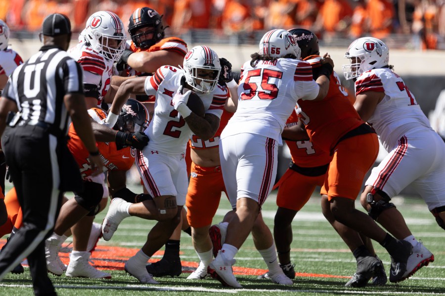 Utah running back Micah Bernard (2) runs past Oklahoma State defensive end Obi Ezeigbo (33) in the first half of an NCAA college football game Saturday, Sept. 21, 2024, in Stillwater, Okla. (AP Photo/Mitch Alcala)