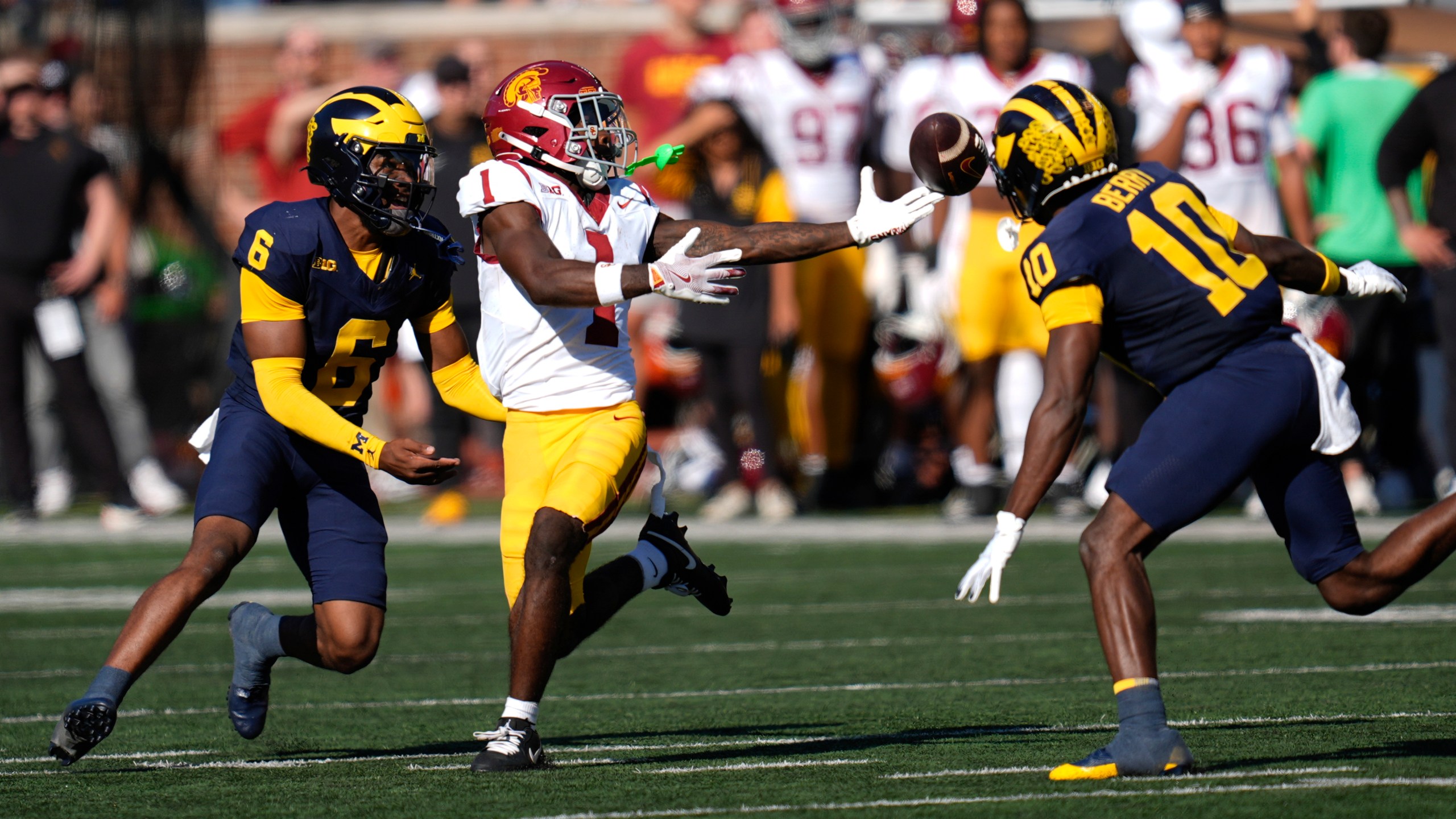 Michigan defensive back Zeke Berry (10) breaks up a pass intended for Southern California wide receiver Zachariah Branch (1) as Brandyn Hillman (6) looks on in the first half of an NCAA college football game in Ann Arbor, Mich., Saturday, Sept. 21, 2024. (AP Photo/Paul Sancya)