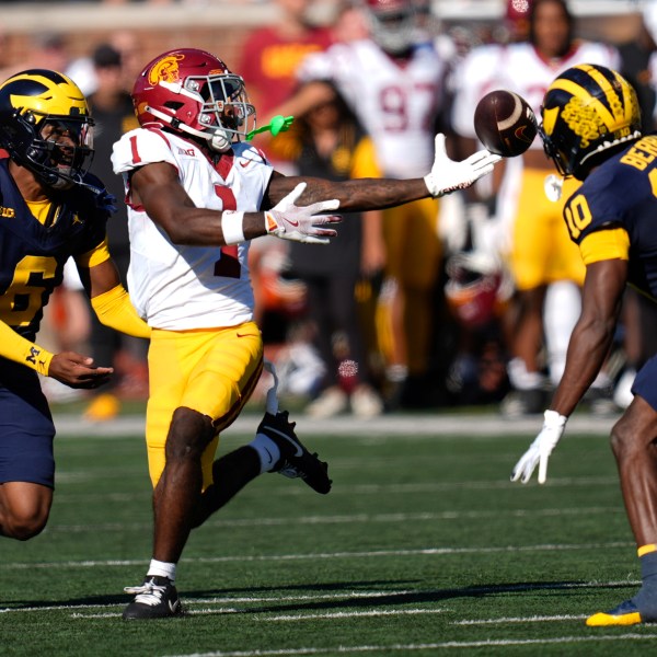 Michigan defensive back Zeke Berry (10) breaks up a pass intended for Southern California wide receiver Zachariah Branch (1) as Brandyn Hillman (6) looks on in the first half of an NCAA college football game in Ann Arbor, Mich., Saturday, Sept. 21, 2024. (AP Photo/Paul Sancya)