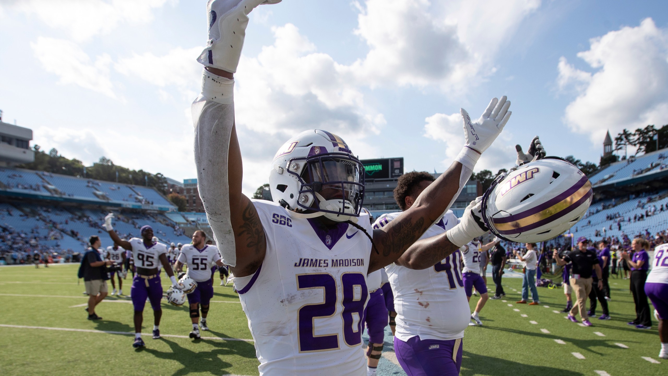 James Madison running back Jobi Malary (28) celebrates with fans after an NCAA college football game against North Carolina in Chapel Hill, N.C., Saturday, Sept. 21, 2024. (Daniel Lin/Daily News-Record via AP)