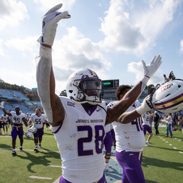 James Madison running back Jobi Malary (28) celebrates with fans after an NCAA college football game against North Carolina in Chapel Hill, N.C., Saturday, Sept. 21, 2024. (Daniel Lin/Daily News-Record via AP)