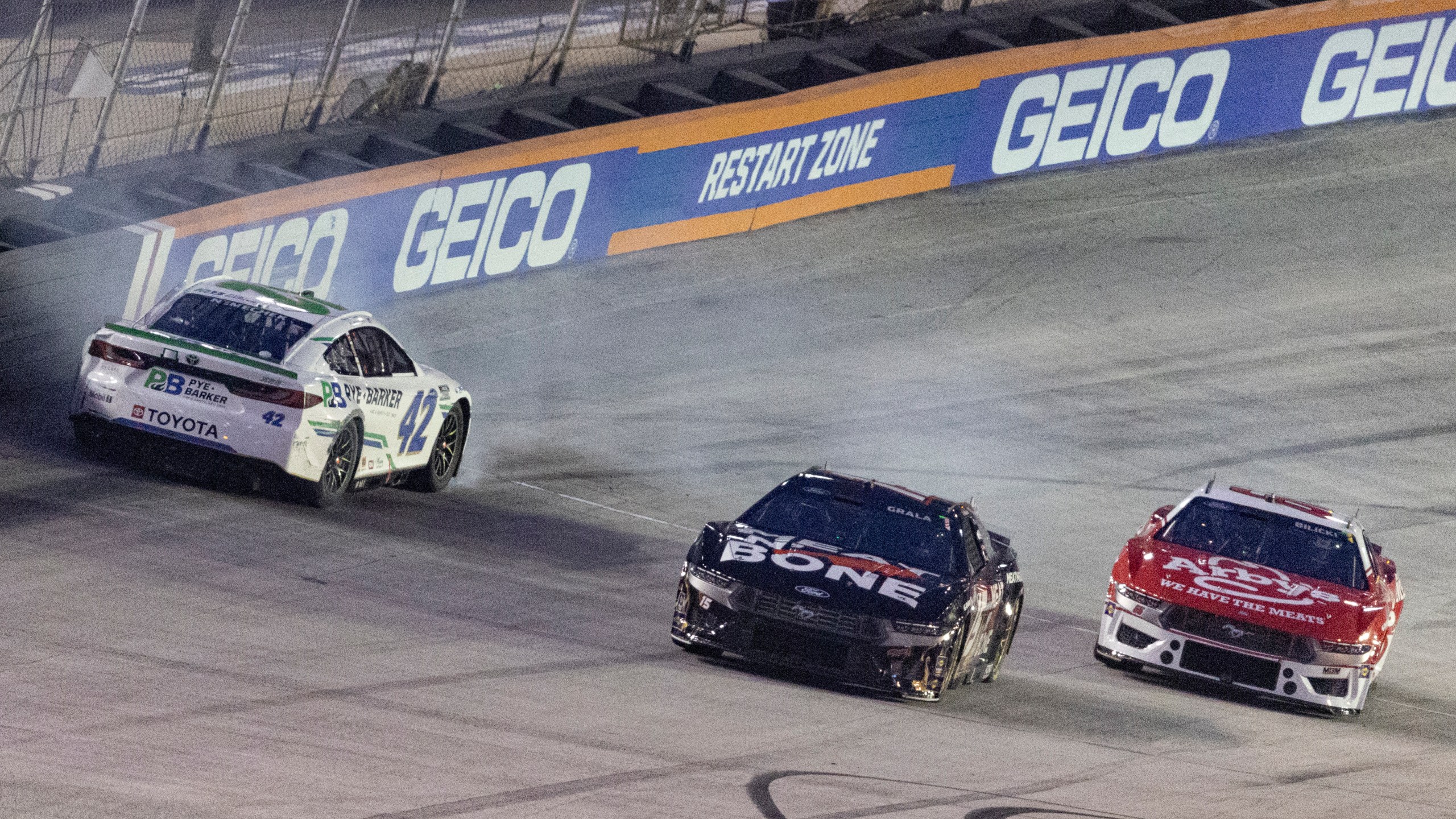 John Hunter Nemechek (42) spins while coming out of Turn 4 as Kaz Grala (15) and Josh Bilicki (66) avoid him during a NASCAR Cup Series auto race, Saturday, Sept. 21, 2024, in Bristol, Tenn. (AP Photo/Wade Payne)