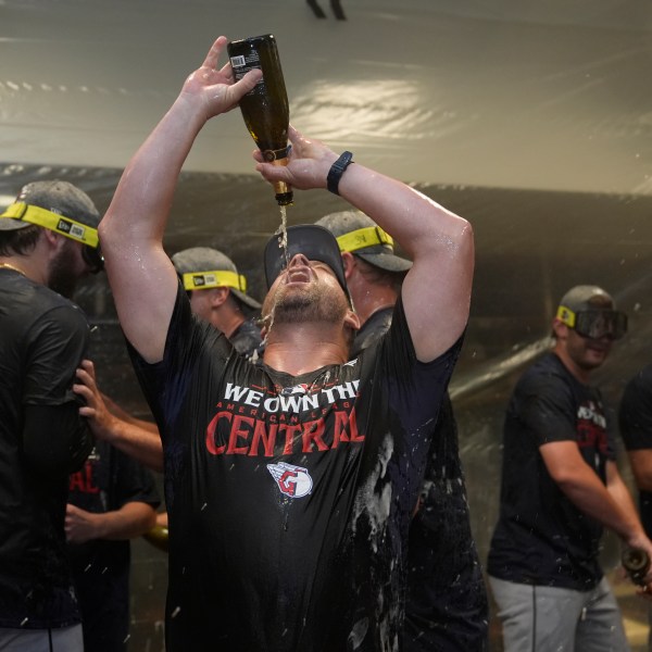 Cleveland Guardians manager Stephen Vogt celebrates in the clubhouse following a baseball game against the St. Louis Cardinals and winning the American League Central Saturday, Sept. 21, 2024, in St. Louis. (AP Photo/Jeff Roberson)