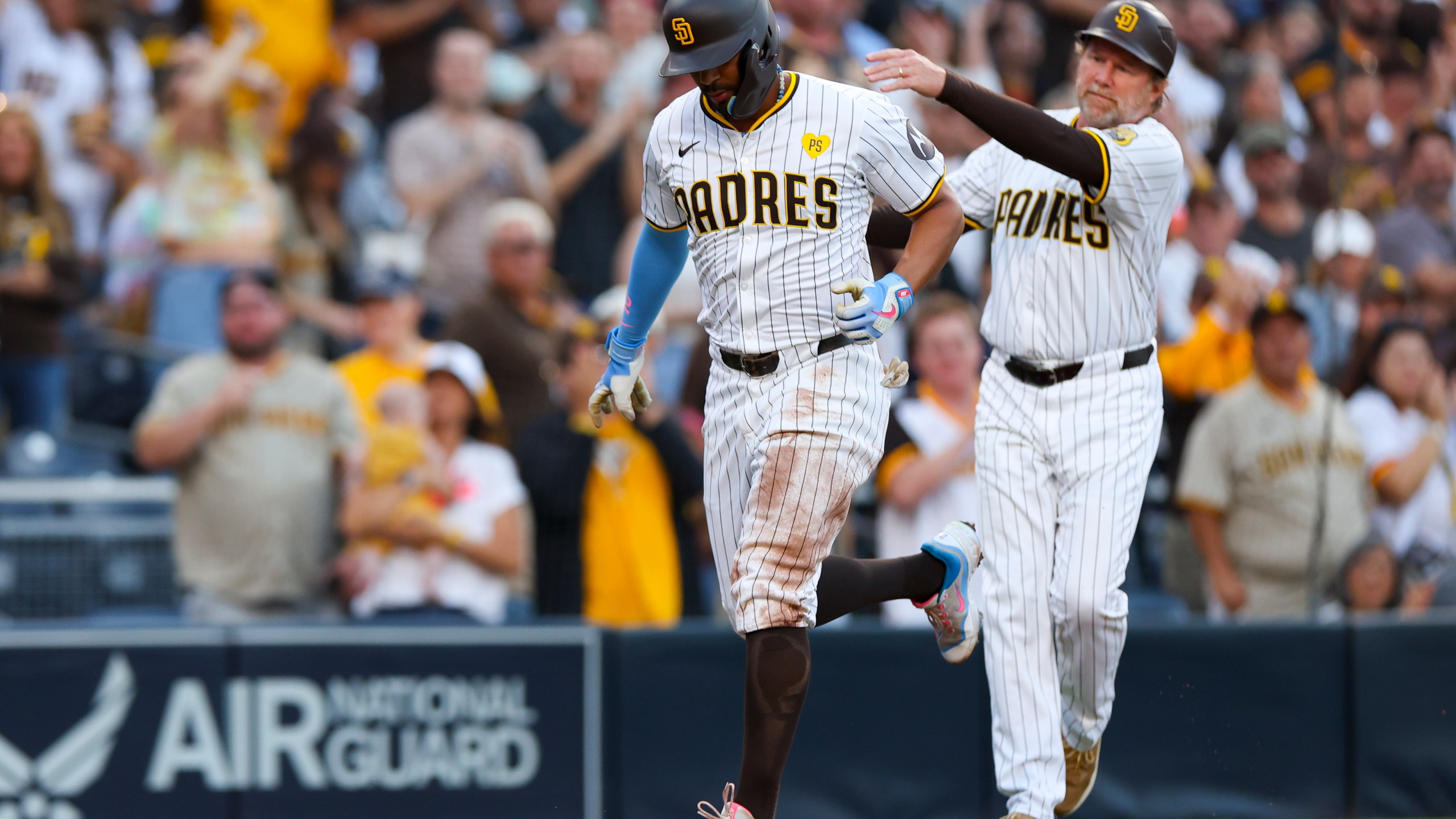 San Diego Padres' Xander Bogaerts, left, celebrates a two-run home run with third base coach Tim Leiper during the second inning of a baseball game against the Chicago White Sox, Saturday, Sept. 21, 2024, in San Diego. (AP Photo/Ryan Sun)