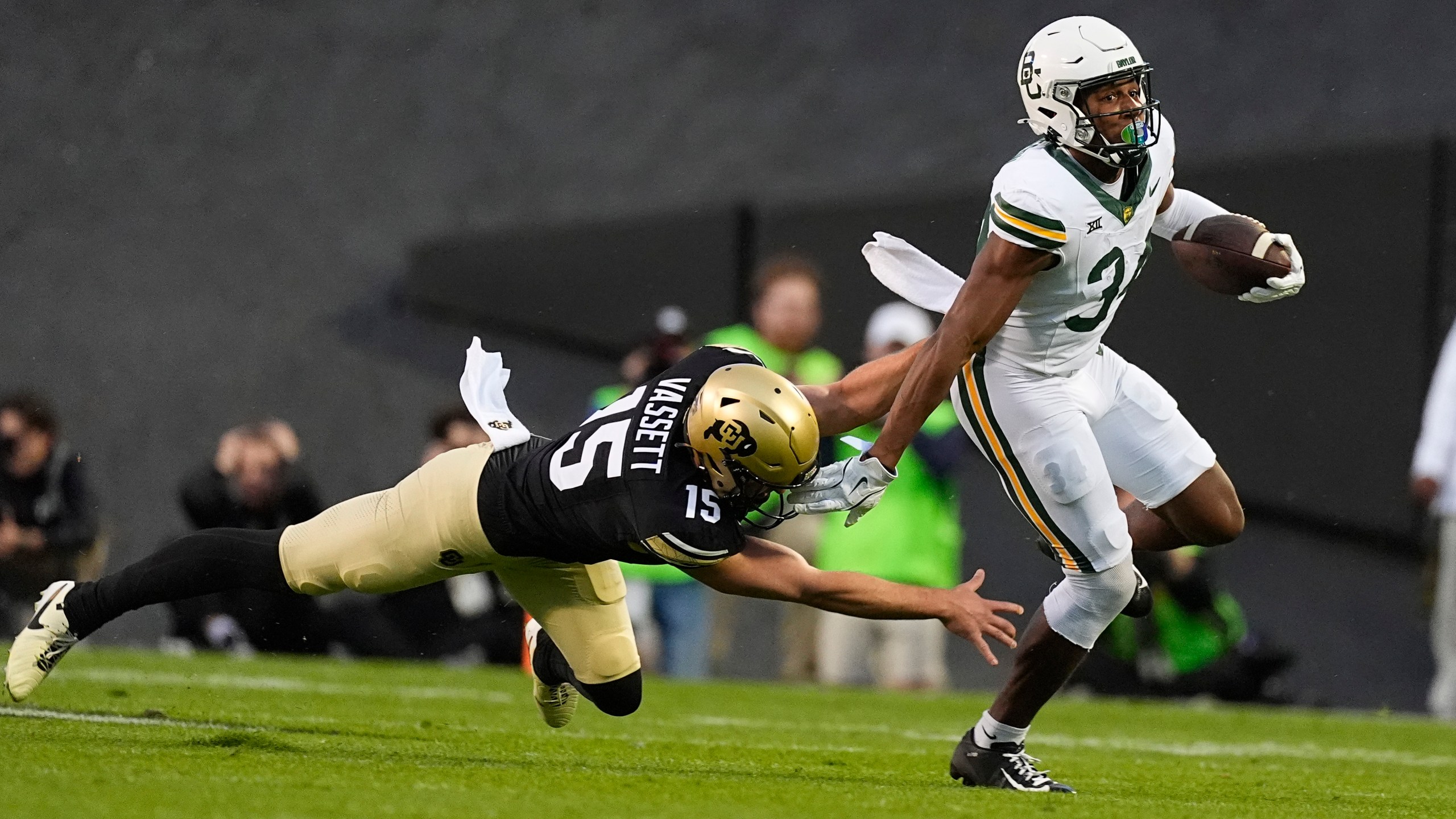 Baylor punt returner Josh Cameron, right, slips away from Colorado's Mark Vassett for a long return in the first half of an NCAA college football game Saturday, Sept. 21, 2024, in Boulder, Colo. (AP Photo/David Zalubowski)