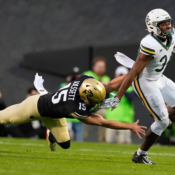 Baylor punt returner Josh Cameron, right, slips away from Colorado's Mark Vassett for a long return in the first half of an NCAA college football game Saturday, Sept. 21, 2024, in Boulder, Colo. (AP Photo/David Zalubowski)