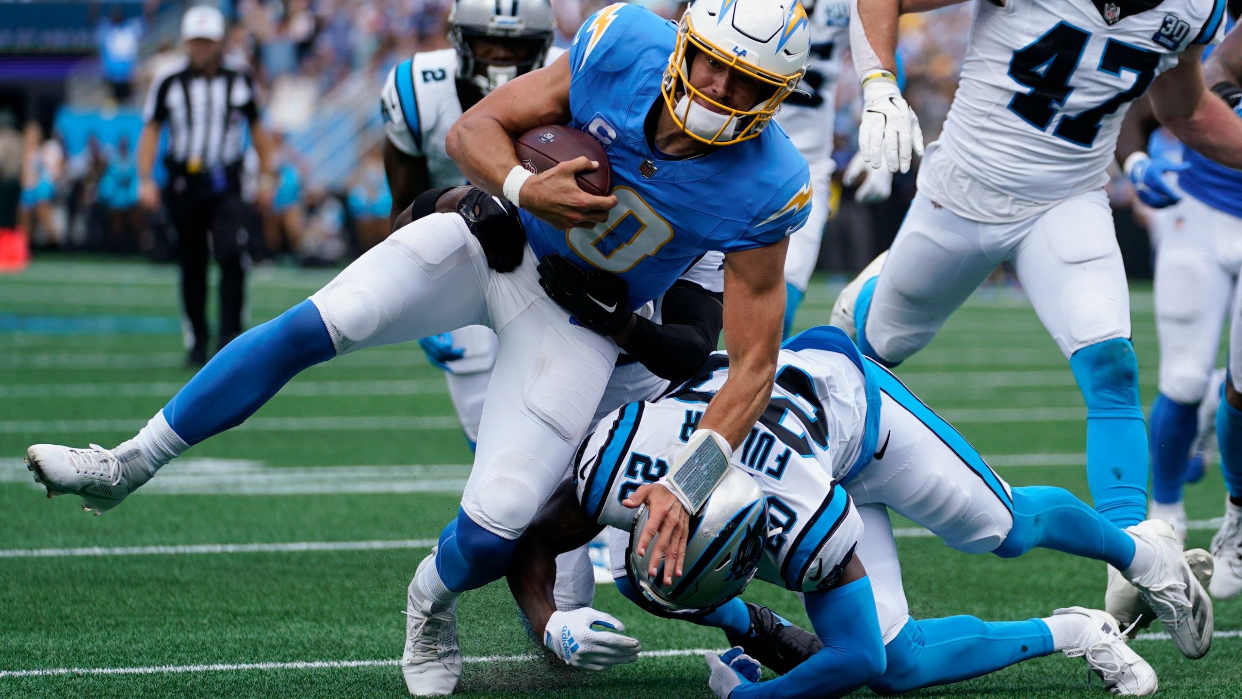 Los Angeles Chargers quarterback Justin Herbert runs against the Carolina Panthers during the first half of an NFL football game on Sunday, Sept. 15, 2024, in Charlotte, N.C. (AP Photo/Erik Verduzco)