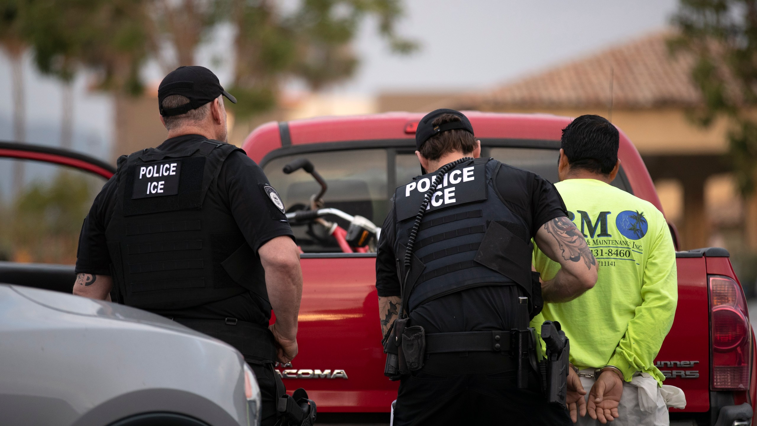 In this July 8, 2019, photo, a U.S. Immigration and Customs Enforcement (ICE) officers detain a man during an operation in Escondido, Calif. (AP Photo/Gregory Bull)