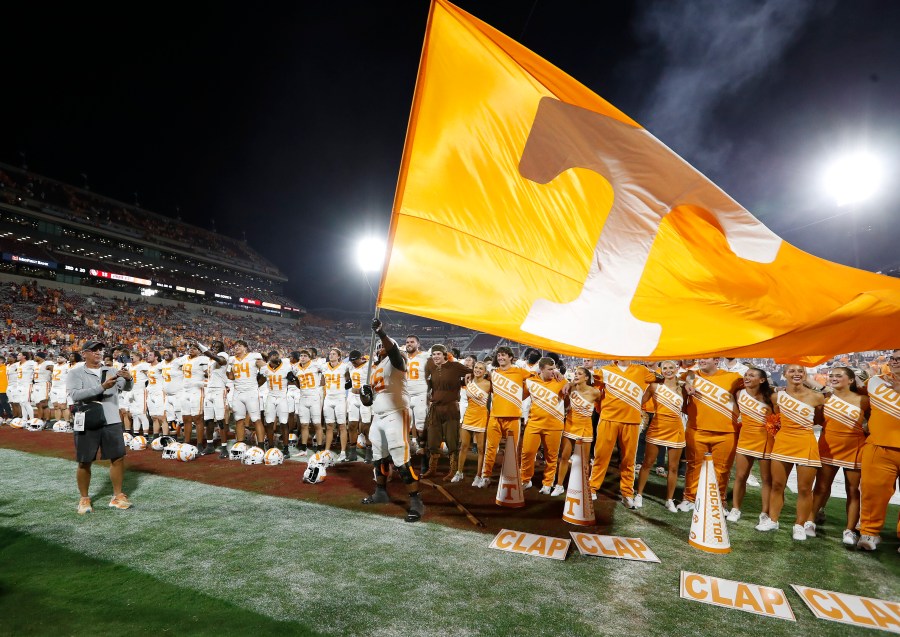 Tennessee offensive lineman Javontez Spraggins (76) waves a giant Tennessee flag after his team defeated Oklahoma in an NCAA college football game Saturday, Sept. 21, 2024, in Norman, Okla. (AP Photo/Alonzo Adams)