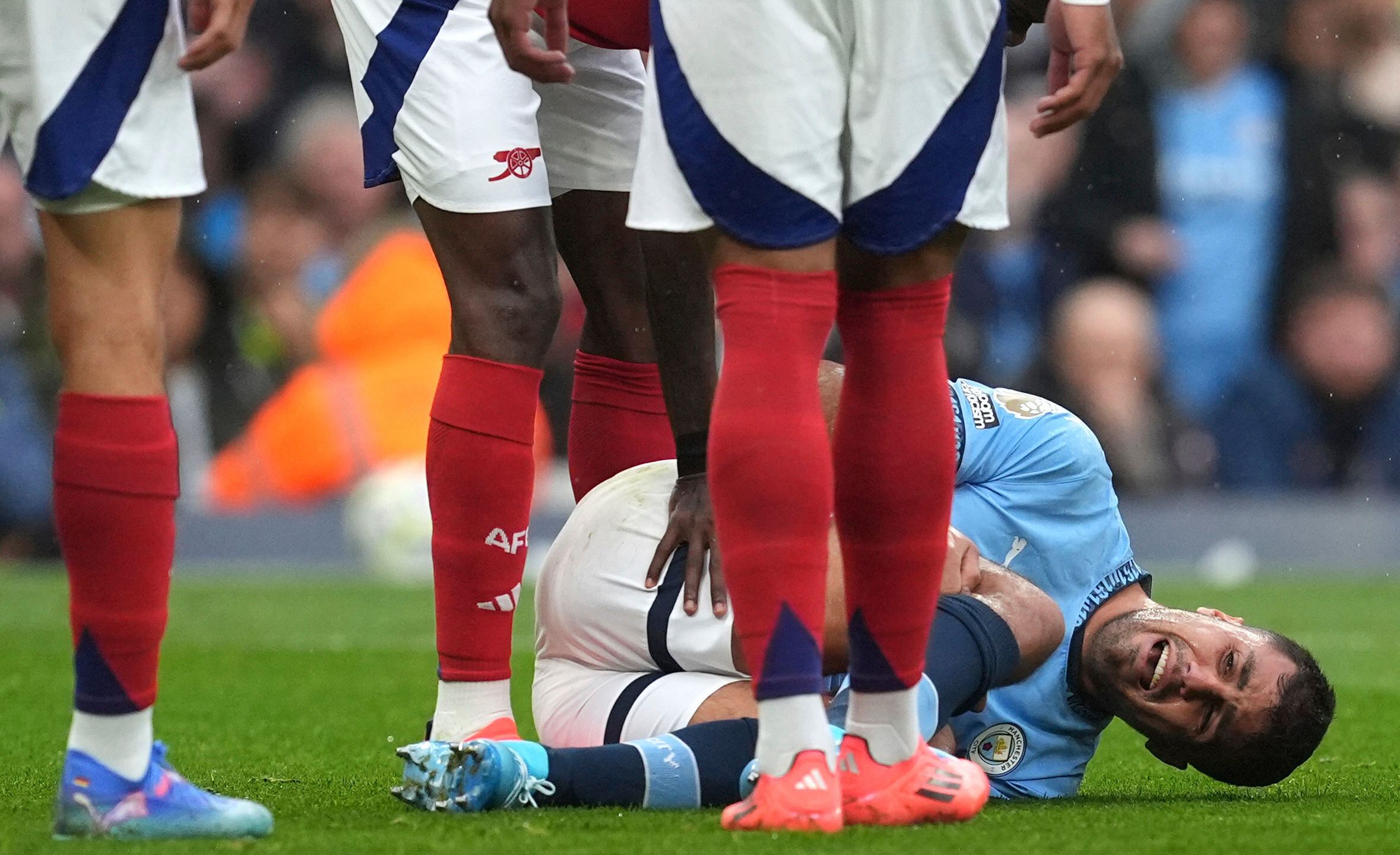 Manchester City's Rodri reacts to an injury, during the English Premier League soccer match between Manchester City and Arsenal at the Etihad stadium in Manchester, England, Sunday, Sept. 22, 2024. (Martin Rickett/PA via AP)