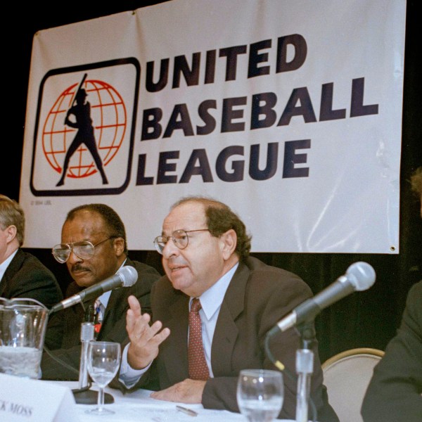 FILE - Agent Dick Moss, second from right, Donald Fehr's predecessor as general counsel of the Major League Players Association, answers a question at a New York news conference, Nov. 1, 1994, announcing the formation of the United Baseball League. From left are Smith College economics professor Andrew Zimbalist; Rep. John Bryant, D-Texas; former major leaguer Curt Flood; Moss, and Robert Mrazek. (AP Photo/Marty Lederhandler, File)