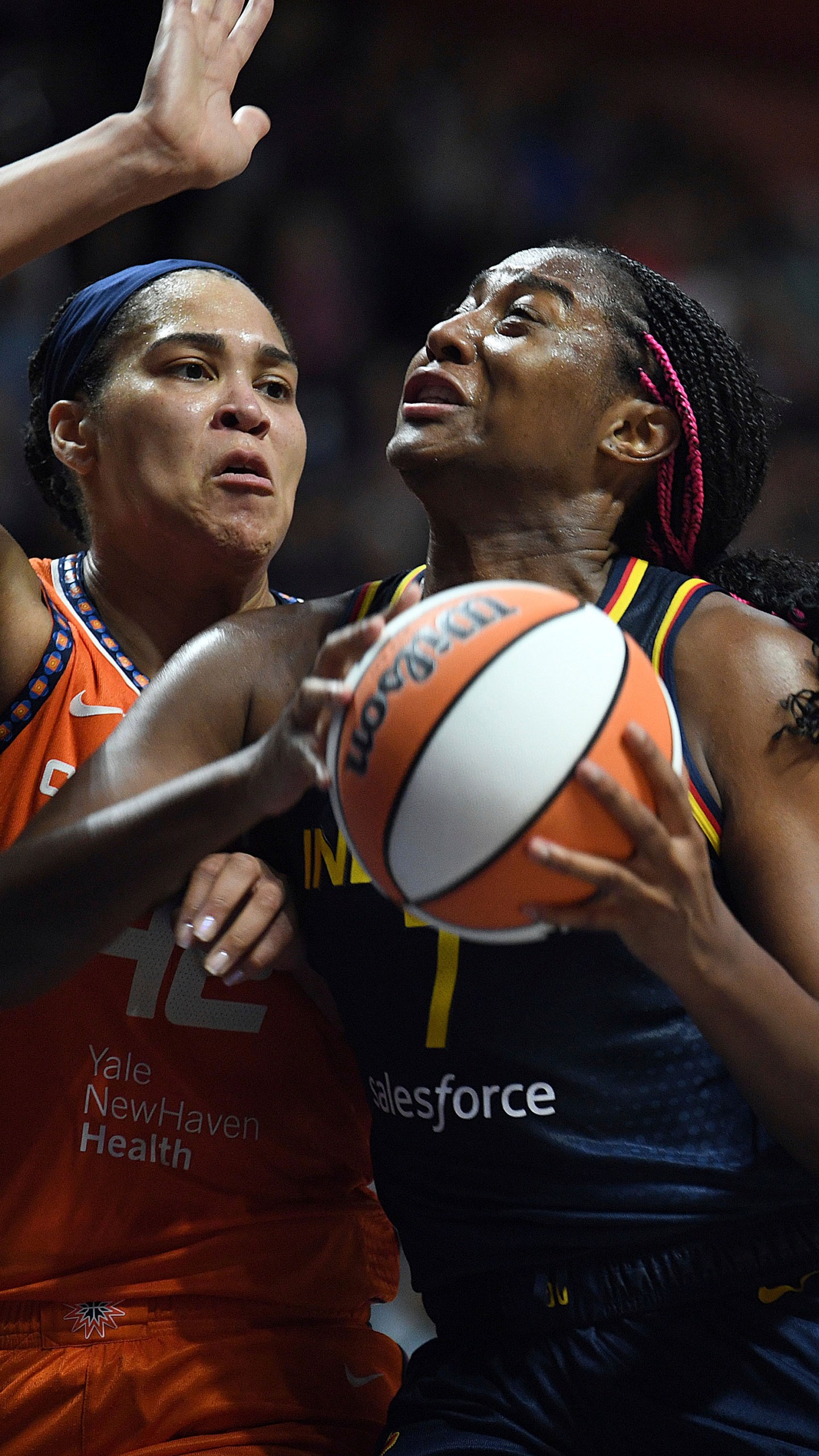 Indiana Fever's Aliyah Boston (7) attempts to move past Connecticut Sun's Brionna Jones (42) during a first-round WNBA basketball playoff game at Mohegan Sun Arena, Sunday, Sept. 22, 2024. (Sarah Gordon/The Day via AP)