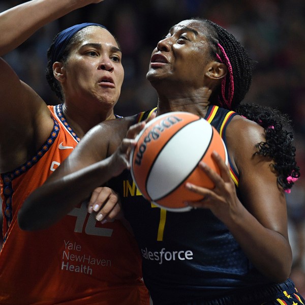 Indiana Fever's Aliyah Boston (7) attempts to move past Connecticut Sun's Brionna Jones (42) during a first-round WNBA basketball playoff game at Mohegan Sun Arena, Sunday, Sept. 22, 2024. (Sarah Gordon/The Day via AP)