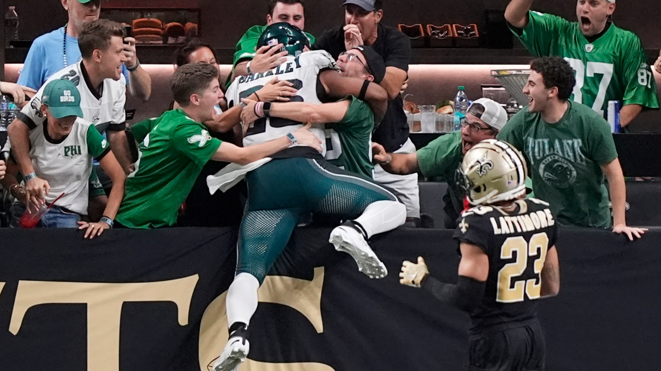 Philadelphia Eagles running back Saquon Barkley celebrates with fans after he ran 65 yards for a touchdown against the New Orleans Saints in the second half of an NFL football game in New Orleans, Sunday, Sept. 22, 2024. (AP Photo/Gerald Herbert)