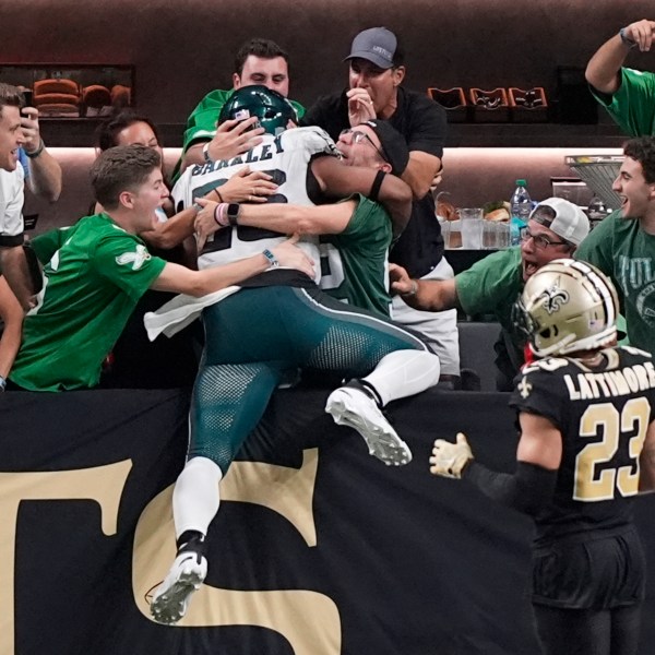 Philadelphia Eagles running back Saquon Barkley celebrates with fans after he ran 65 yards for a touchdown against the New Orleans Saints in the second half of an NFL football game in New Orleans, Sunday, Sept. 22, 2024. (AP Photo/Gerald Herbert)