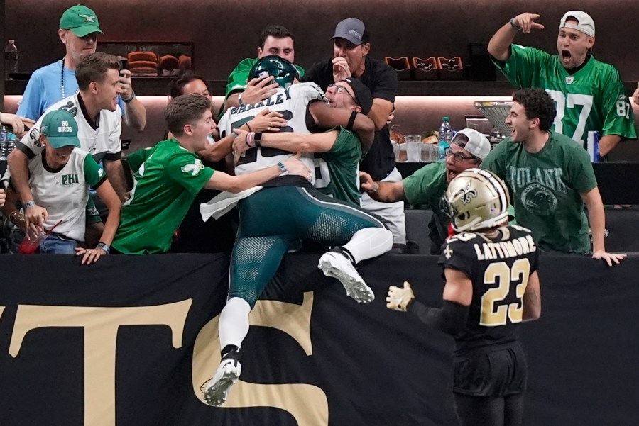 Philadelphia Eagles running back Saquon Barkley celebrates with fans after he ran 65 yards for a touchdown against the New Orleans Saints in the second half of an NFL football game in New Orleans, Sunday, Sept. 22, 2024. (AP Photo/Gerald Herbert)