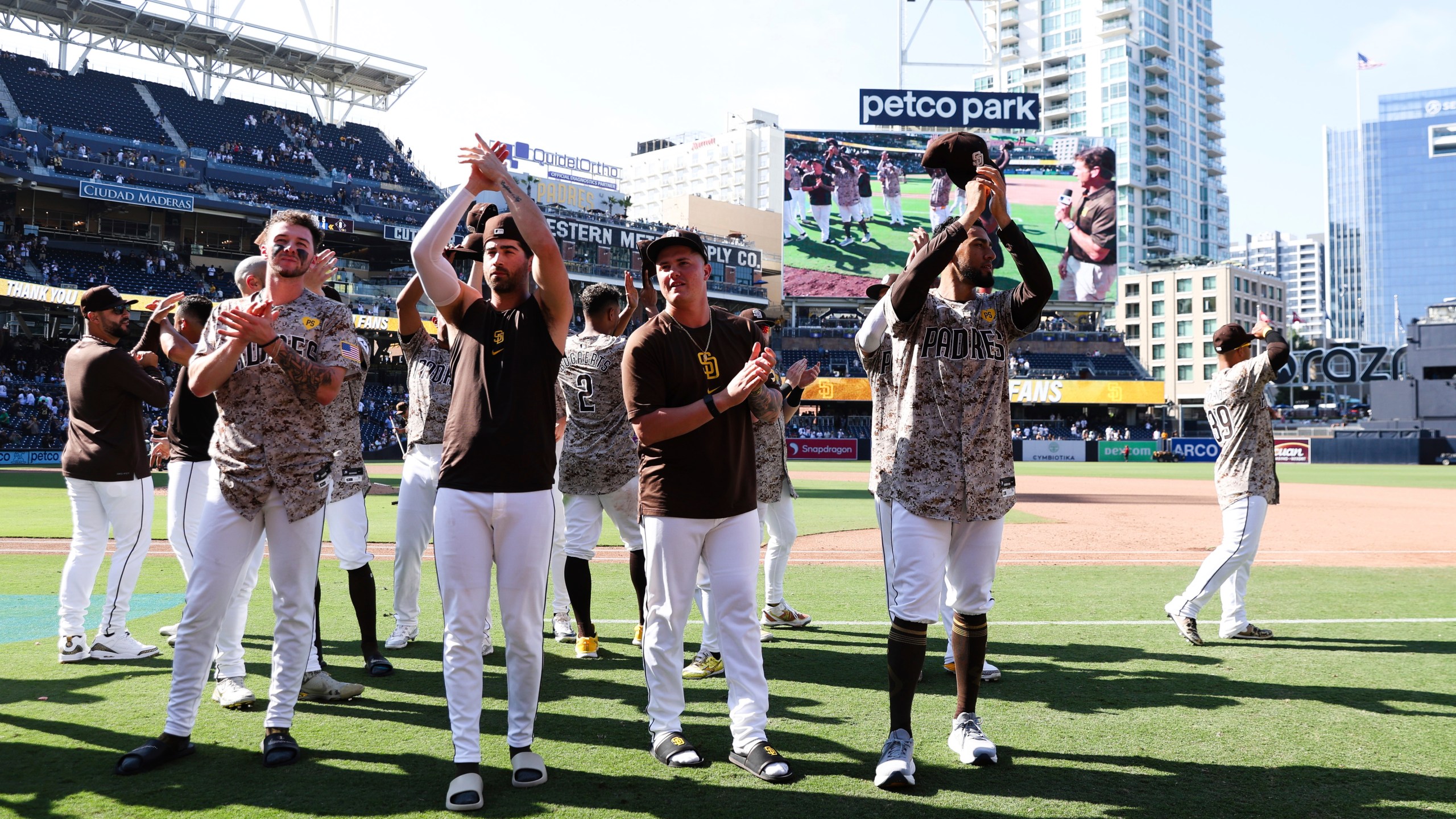 From left to right, San Diego Padres' Jackson Merrill, Tyler Wade, Adrian Morejon, and Robert Suarez acknowledge the fans after the team defeated the Chicago White Sox in a baseball game, Sunday, Sept. 22, 2024, in San Diego. (AP Photo/Derrick Tuskan)