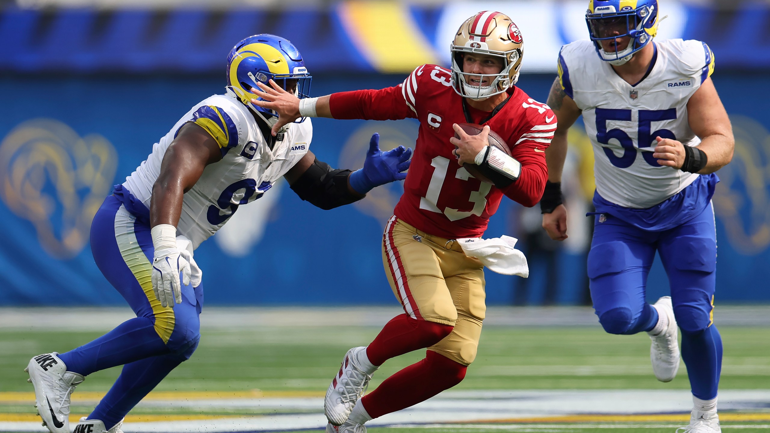 San Francisco 49ers quarterback Brock Purdy (13) runs against Los Angeles Rams defensive tackle Kobie Turner, left, and defensive tackle Braden Fiske (55) during the second half of an NFL football game, Sunday, Sept. 22, 2024, in Inglewood, Calif. (AP Photo/Ryan Sun)