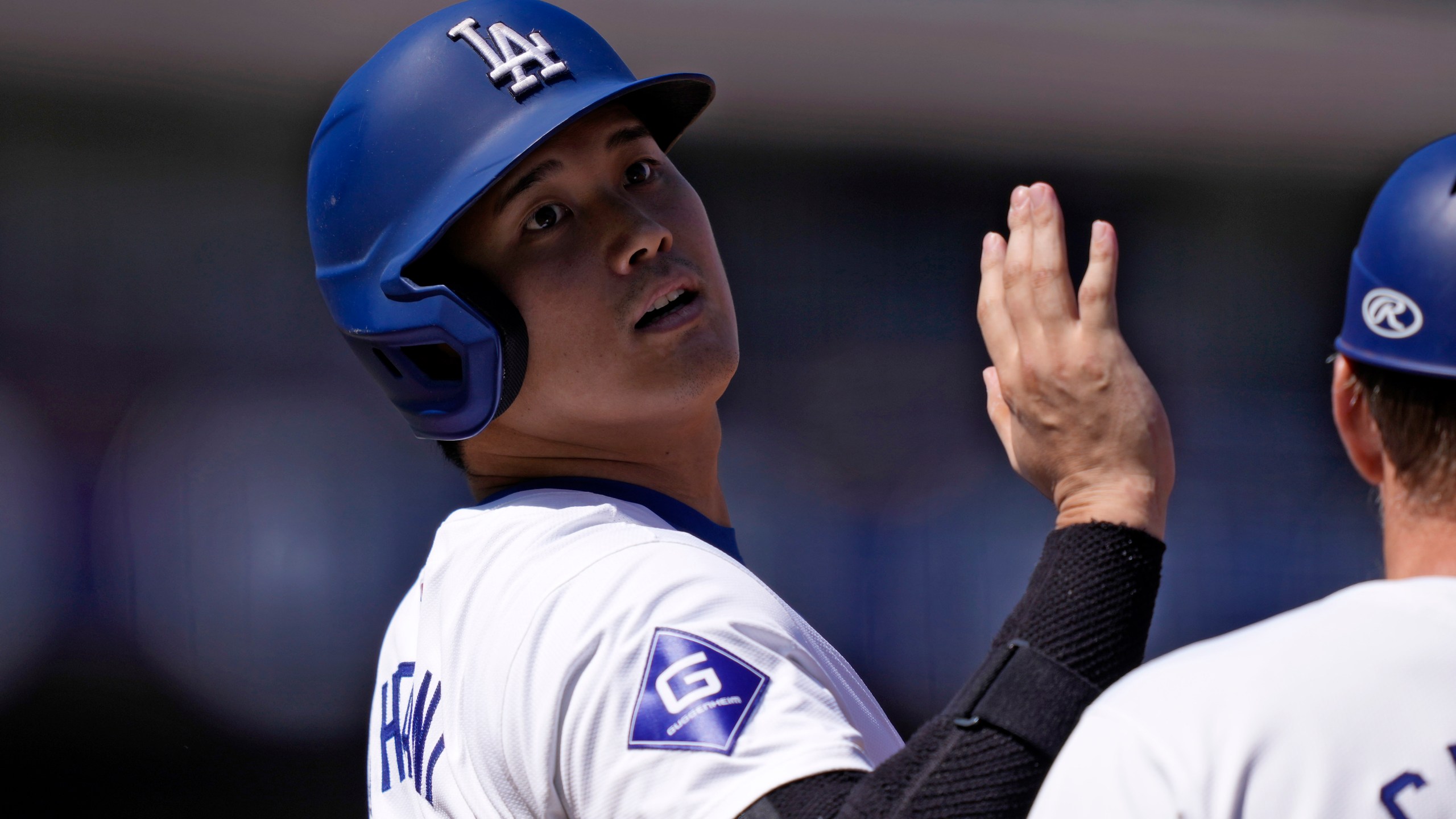 Los Angeles Dodgers' Shohei Ohtani acknowledges the first base umpire after hitting a single during the first inning of a baseball game against the Colorado Rockies, Sunday, Sept. 22, 2024, in Los Angeles. (AP Photo/Mark J. Terrill)