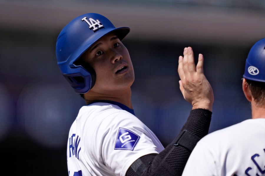 Los Angeles Dodgers' Shohei Ohtani acknowledges the first base umpire after hitting a single during the first inning of a baseball game against the Colorado Rockies, Sunday, Sept. 22, 2024, in Los Angeles. (AP Photo/Mark J. Terrill)