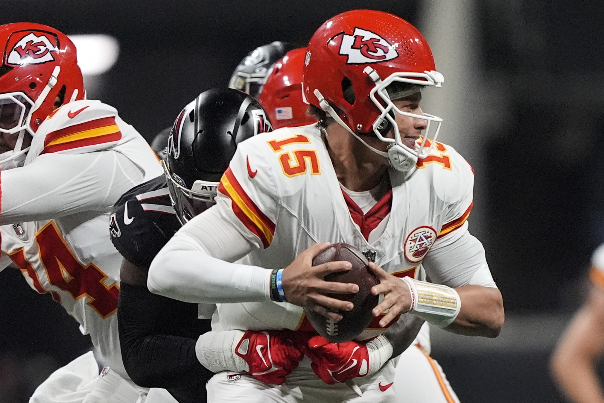 Kansas City Chiefs quarterback Patrick Mahomes (15) is hit by Atlanta Falcons linebacker Arnold Ebiketie (17) during the first half of an NFL football game, Sunday, Sept. 22, 2024, in Atlanta. (AP Photo/Brynn Anderson)