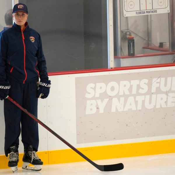 Christine Bumstead, a performance coach for the Saskatoon Blades in Canada's Western Hockey League, watches as Florida Panthers players do drills during NHL hockey training camp, Thursday, Sept. 19, 2024, in Fort Lauderdale, Fla. Bumstead is working as part of the Panthers coaching staff during training camp. (AP Photo/Lynne Sladky)