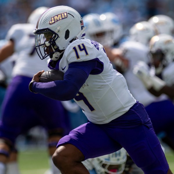 James Madison quarterback Alonza Barnett III (14) drives the ball around North Carolina defense during the first half of an NCAA college football game in Chapel Hill, N.C., Saturday, Sept. 21, 2024. (Daniel Lin/Daily News-Record via AP)