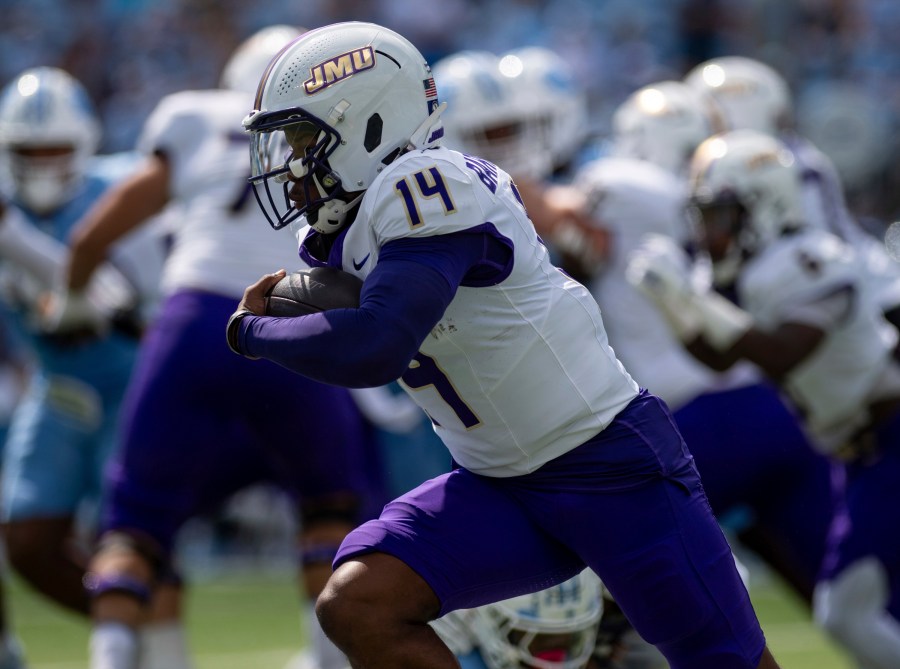 James Madison quarterback Alonza Barnett III (14) drives the ball around North Carolina defense during the first half of an NCAA college football game in Chapel Hill, N.C., Saturday, Sept. 21, 2024. (Daniel Lin/Daily News-Record via AP)