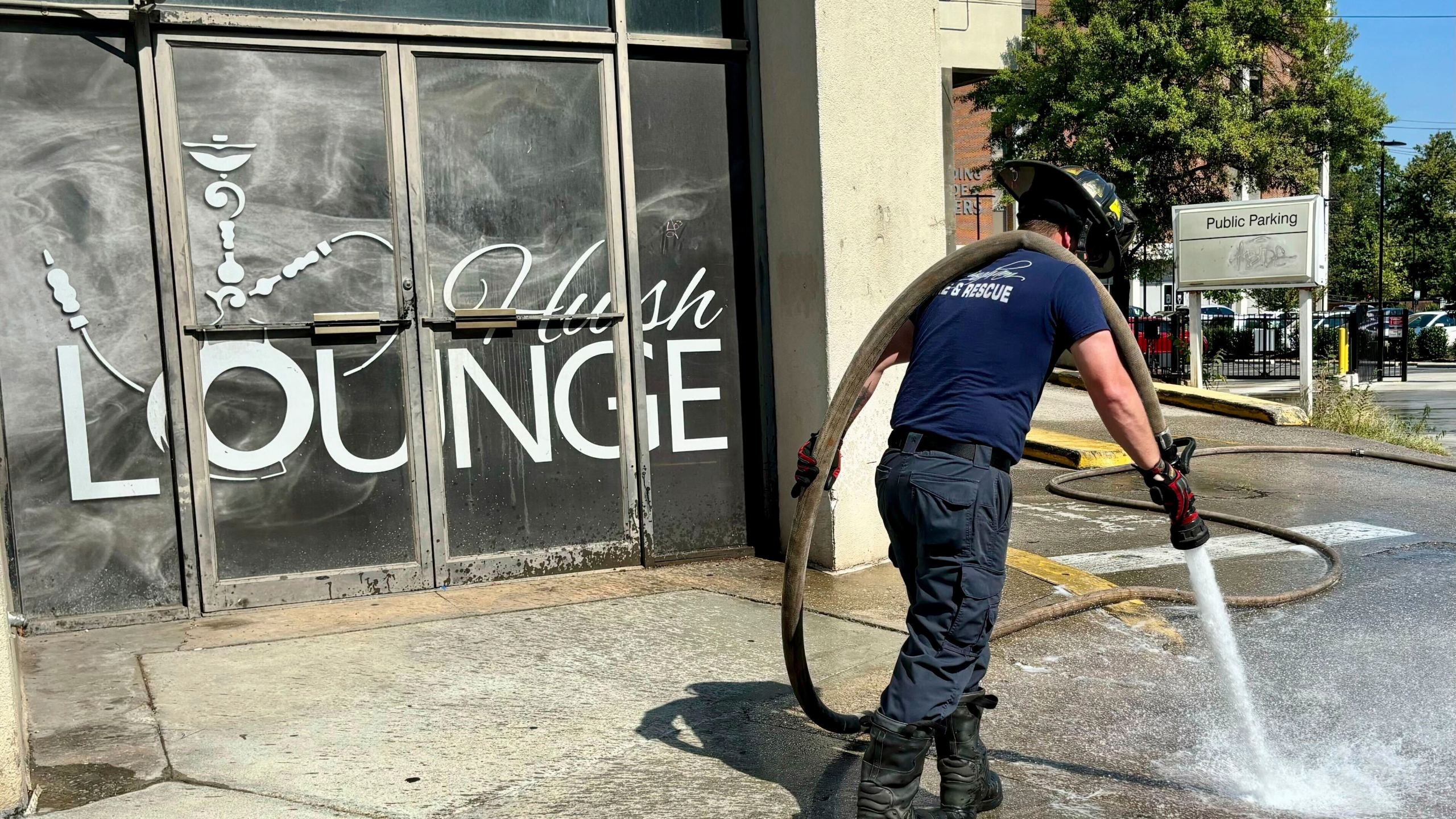 A firefighter cleans blood stains off the sidewalk outside a nightclub in Birmingham, Ala. on Sunday, Sept. 22, 2024, after a mass shooting took place. (AP Photo/Kim Chandler)