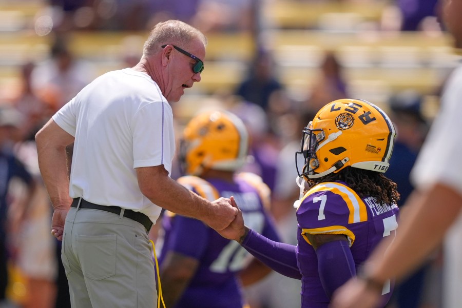 LSU head coach Brian Kelly greets linebacker Harold Perkins Jr. (7) before an NCAA college football game against UCLA in Baton Rouge, La., Saturday, Sept. 21, 2024. (AP Photo/Gerald Herbert)