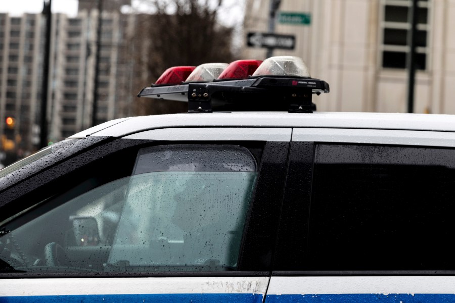 FILE - A police officer sits in a car near the Brooklyn Bridge, Dec. 16, 2022, in the Brooklyn borough of New York. (AP Photo/Julia Nikhinson, file)