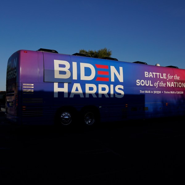 FILE - Democratic presidential candidate former Vice President Joe Biden and Democratic vice presidential candidate Sen. Kamala Harris, D-Calif., ride on a bus in Phoenix, Oct. 8, 2020, on a small business bus tour. (AP Photo/Carolyn Kaster, File)