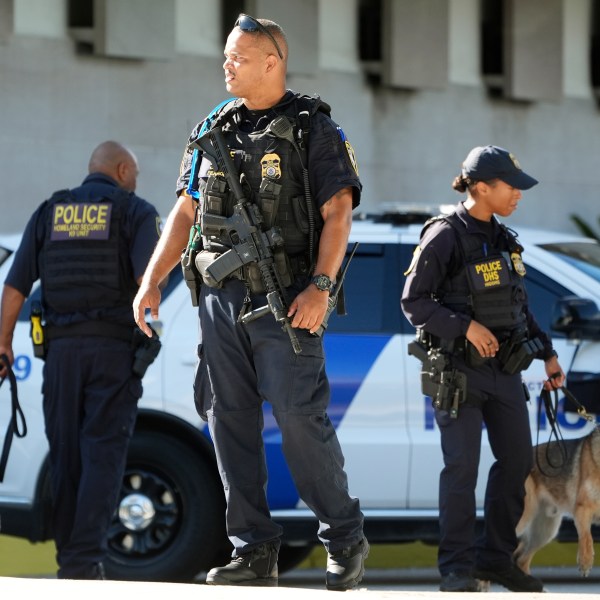 Department of Homeland Security officers patrol outside the Paul G. Rogers Federal Building and U.S. Courthouse, where Ryan Wesley Routh, 58, suspected in an apparent assassination attempt targeting former President Donald Trump, will be attending a hearing, Monday, Sept. 23, 2024, in West Palm Beach, Fla. (AP Photo/Wilfredo Lee)