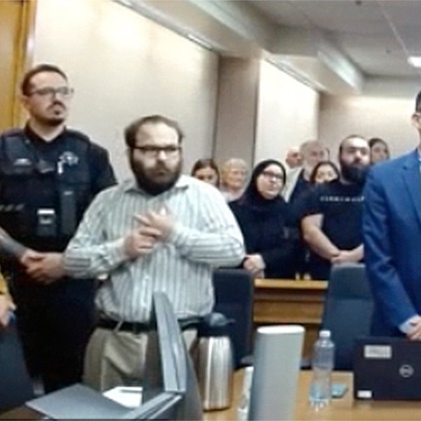 In this image taken from video provided by the Colorado Judicial Branch, Ahmad Alissa, third from left, stands for the verdict in his trial for the 2021 Colorado supermarket shootings, Monday, Sept 23, 2024, in Boulder, Colo. (Colorado Judicial Branch via AP)