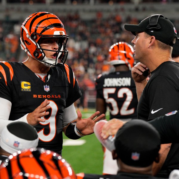 Cincinnati Bengals quarterback Joe Burrow (9) talks with head coach Zac Taylor, right, during the second half of an NFL football game against the Washington Commanders, Monday, Sept. 23, 2024, in Cincinnati. The Commanders won 38-33. (AP Photo/Jeff Dean)