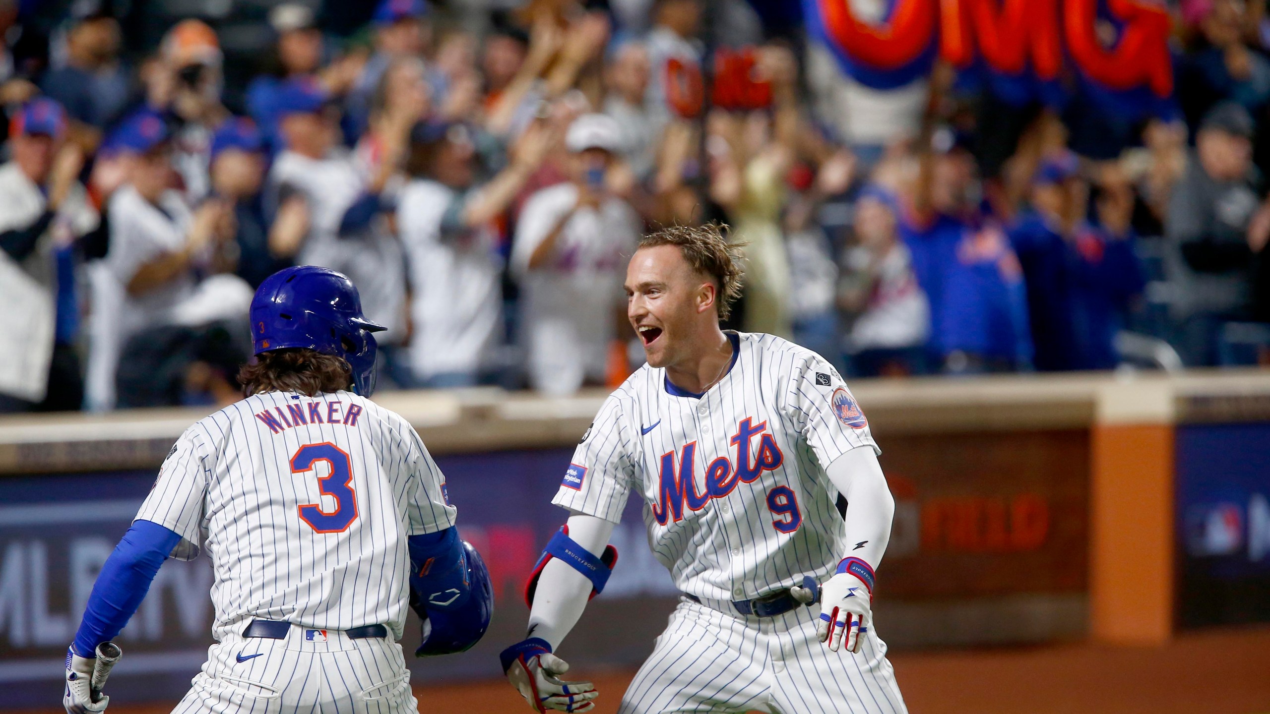 New York Mets' Jesse Winker, left, and Brandon Nimmo celebrate Nimmo's home run in the sixth inning during a baseball game Sunday, Sept. 22, 2024, in New York. (AP Photo/John Munson)