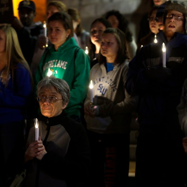 FILE - In this Nov. 19, 2013 file photo, a small group of death penalty opponents stand outside St. Francis Xavier Church during a vigil in protest of the scheduled execution of Missouri death row inmate Joseph Paul Franklin in St. Louis. (AP Photo/Jeff Roberson, File)