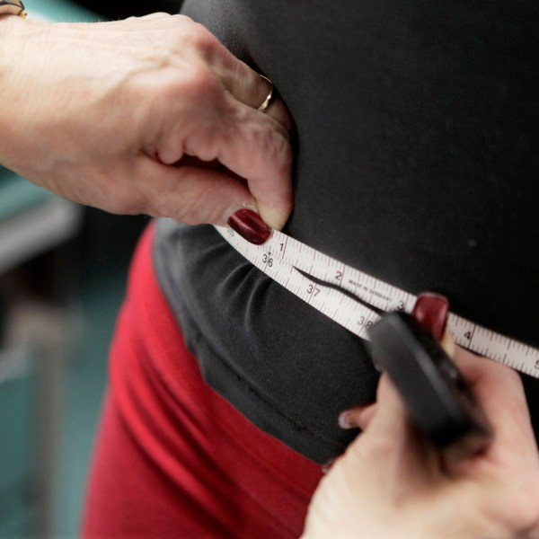 FILE - A subject's waist is measured during an obesity prevention study in Chicago on Jan. 20, 2010. (AP Photo/M. Spencer Green, File)