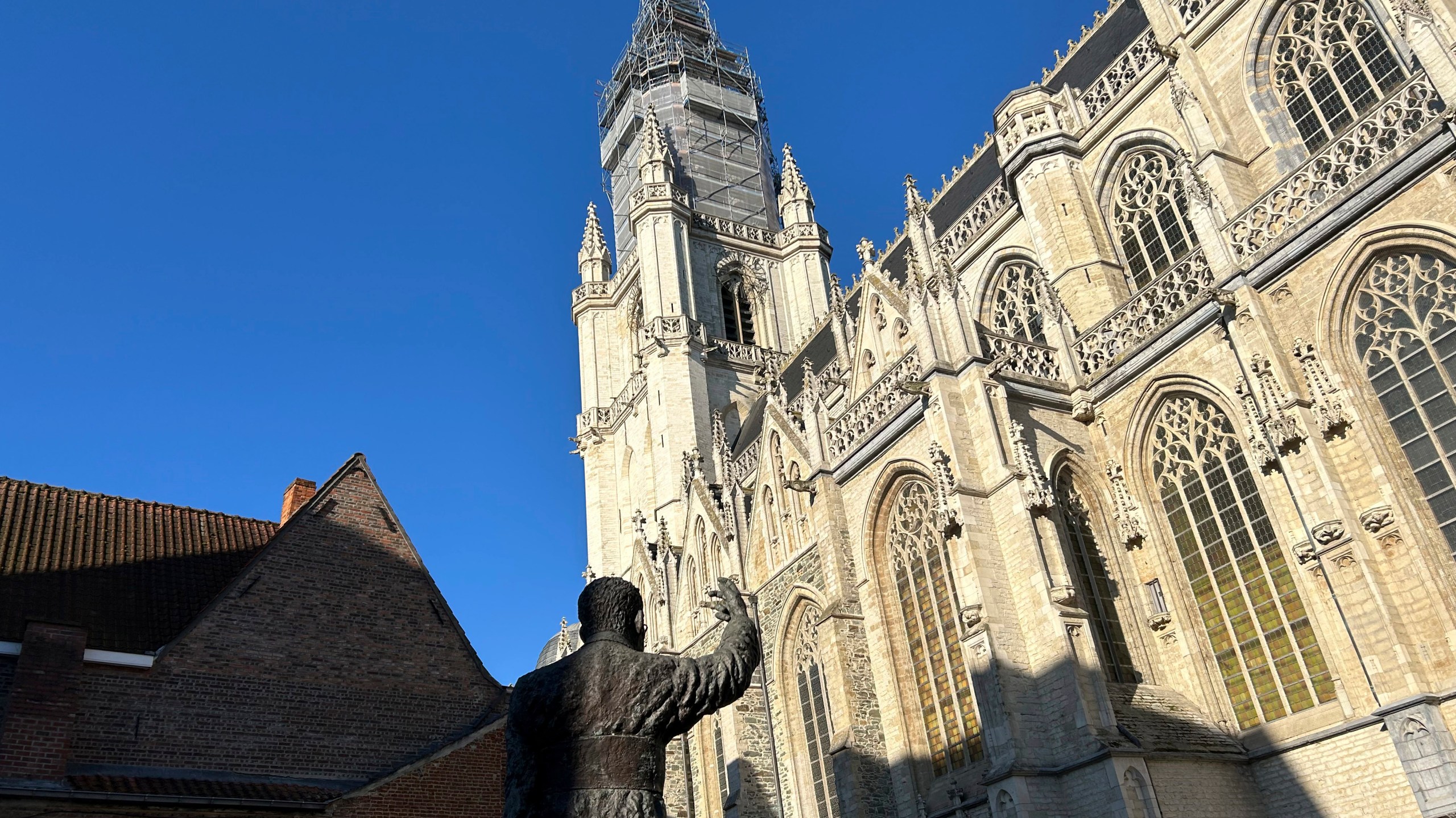 An exterior view of St. Martin's Basilica with the statue of 20th century Cardinal Jozef Cardijn, in Halle, Belgium, Sept. 15, 2024. (AP Photo/Raf Casert)