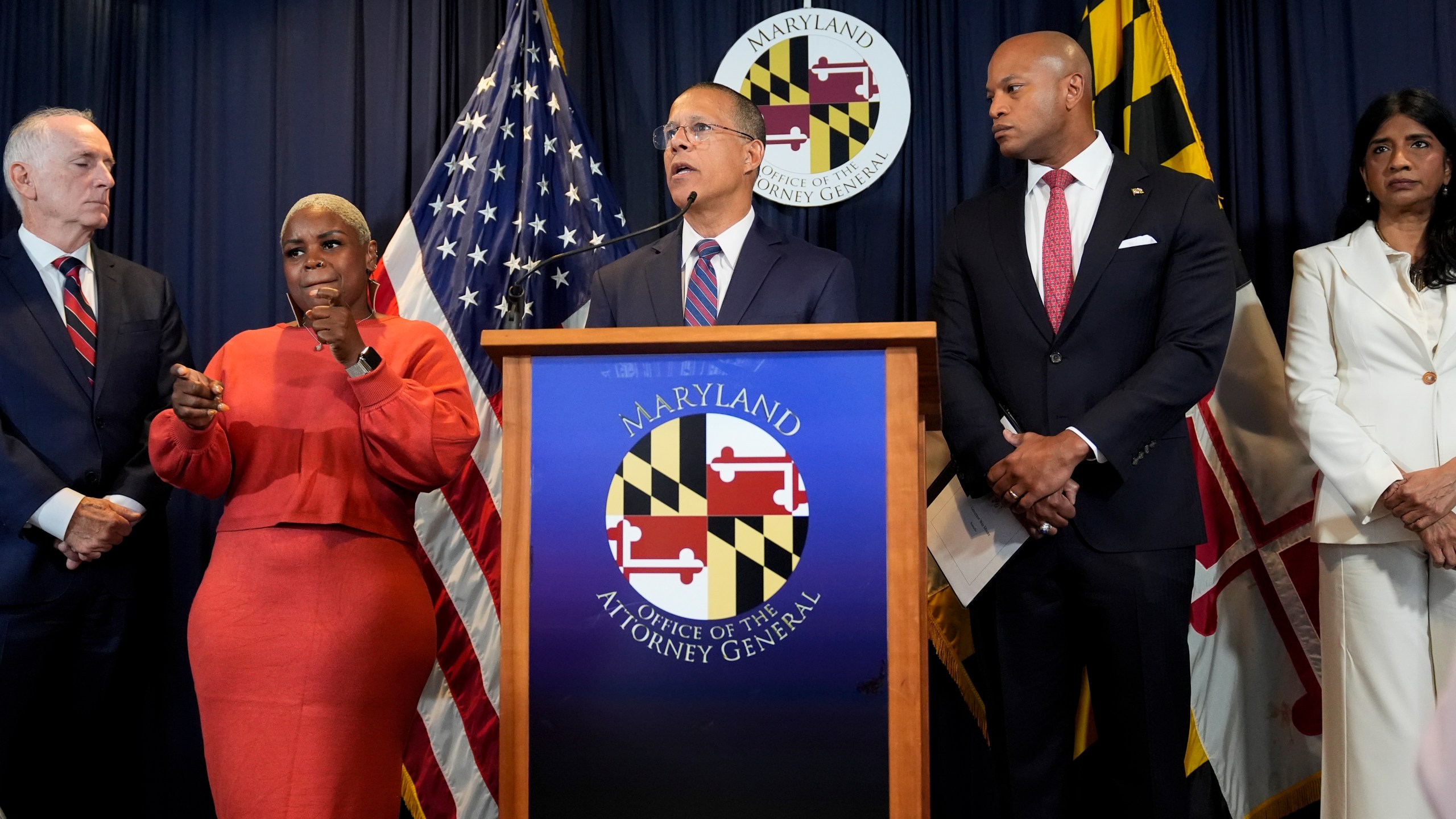 Maryland Attorney General Anthony Brown, center, speaks during a press conference announcing a lawsuit seeking damages from the owners and managers of the Dali cargo ship that crashed into the Francis Key Scott Bridge, Tuesday, Sept. 24, 2024, in Baltimore. (AP Photo/Stephanie Scarbrough)