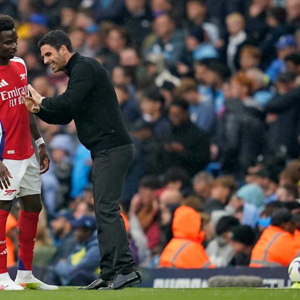 Arsenal's manager Mikel Arteta speaks to Arsenal's Bukayo Saka during the English Premier League soccer match between Manchester City and Arsenal at the Etihad stadium in Manchester, England, Sunday, Sept. 22, 2024. (AP Photo/Dave Thompson)