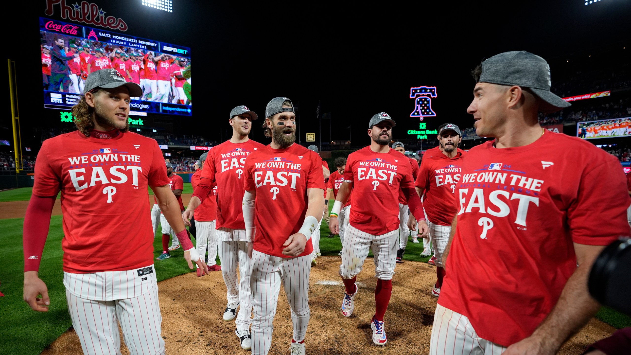 Philadelphia Phillies' Alec Bohm, from left, Jeff Hoffman, Bryce Harper, Kyle Schwarber, Garrett Stubbs and J.T. Realmuto celebrate after winning a baseball game against the Chicago Cubs to clinch the NL East title, Monday, Sept. 23, 2024, in Philadelphia. (AP Photo/Matt Slocum)