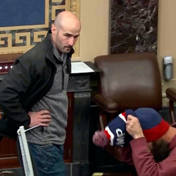 In this image from Senate Television, Leo Christopher Kelly, walks on the floor in the Senate chamber Jan. 6, 2021, at the U.S. Capitol in Washington. The federal Bureau of Prisons mistakenly released Kelly from custody before he finished serving his 30-month sentence for storming the Senate chamber during a mob's attack on the U.S. Capitol, Justice Department prosecutors said in a court filing. (Senate Television via AP)