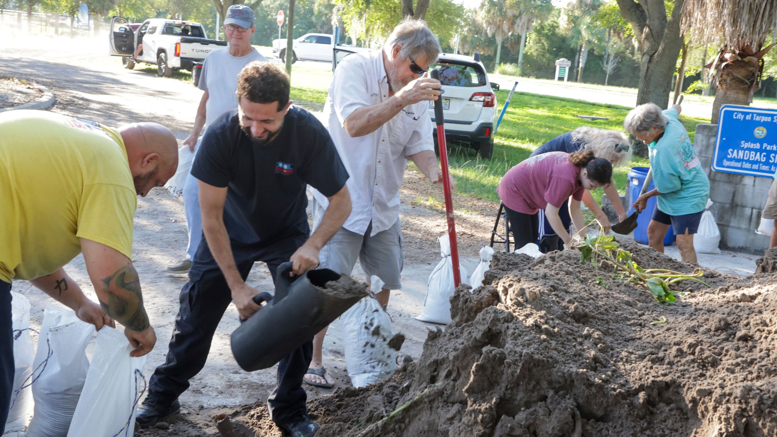 Sandbags are filled at a public site while residents prepare their homes for potential flooding, Tuesday, Sept. 24, 2024, in Tarpon Springs, Fla., as Tropical Storm Helene approaches. (Douglas R. Clifford/Tampa Bay Times via AP)