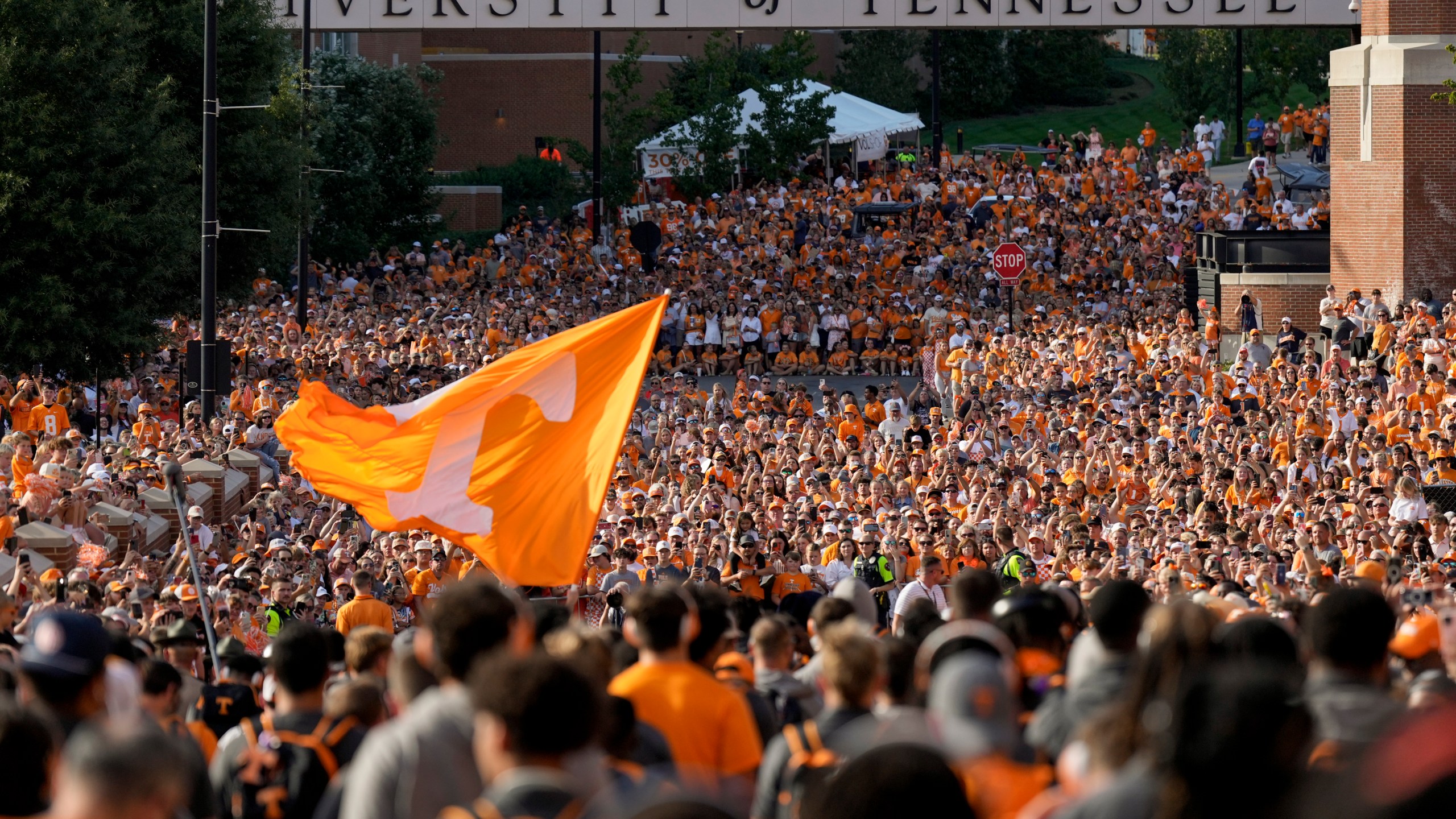 FILE - Tennessee fans gather outside Neyland Stadium before an NCAA college football game between Tennessee and Kent State in Knoxville, Tenn., Sept. 14, 2024. (AP Photo/George Walker IV, File)