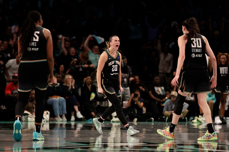 New York Liberty guard Sabrina Ionescu (20) reacts with Breanna Stewart (30) during the first half of a first-round WNBA basketball playoff game against the Atlanta Dream, Tuesday, Sept. 24, 2024, in New York. (AP Photo/Adam Hunger)