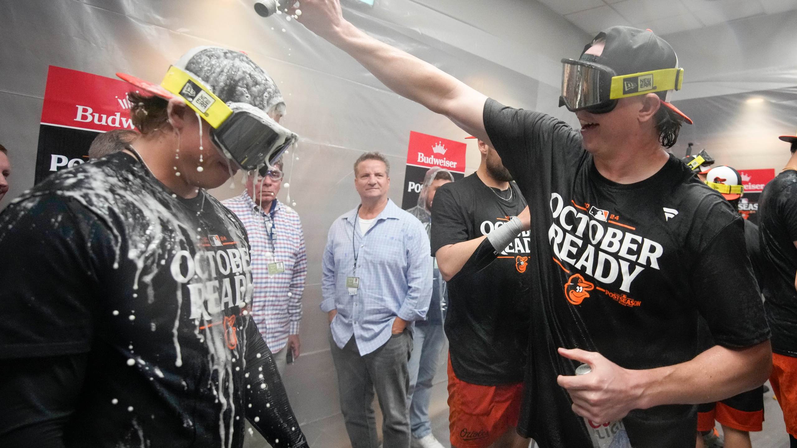 Baltimore Orioles' Jackson Holliday is doused with beer as teammates celebrate after clinching a playoff berth by defeating the New York Yankees in baseball game, Tuesday, Sept. 24, 2024, in New York. (AP Photo/Bryan Woolston)