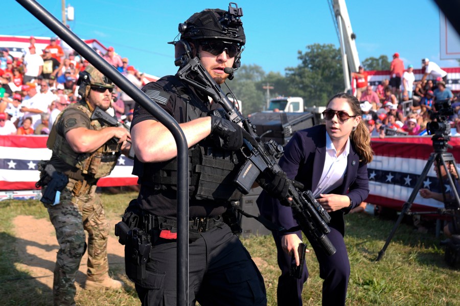 FILE - U.S. Secret Service agents respond as Republican presidential candidate former President Donald Trump is surrounded on stage by U.S. Secret Service agents at a campaign rally, July 13, 2024, in Butler, Pa. (AP Photo/Evan Vucci, File)